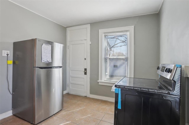 4644 Minnesota Ave, Saint Louis, MO 63111 - kitchen featuring stainless steel appliances, baseboards, and light tile patterned floors