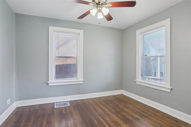 4644 Minnesota Ave, Saint Louis, MO 63111 - unfurnished room with plenty of natural light, baseboards, dark wood-style floors, and ceiling fan