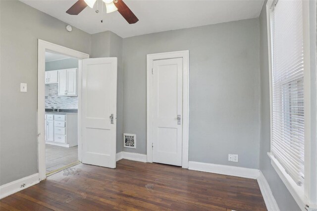4644 Minnesota Ave, Saint Louis, MO 63111 - unfurnished bedroom featuring wood finished floors, baseboards, and a ceiling fan