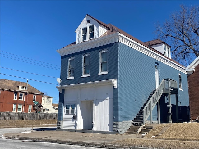 640 N 12th St, Quincy, IL 63201 - view of front of home featuring stairs, fence, and brick siding