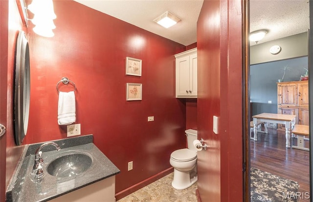 5819 Highway Vv Hwy, Vv, MO 65542 - bathroom featuring baseboards, toilet, vanity, and a textured ceiling