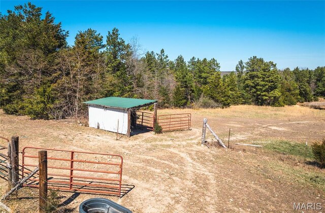 5819 Highway Vv Hwy, Vv, MO 65542 - view of yard featuring an outdoor structure, fence, and a forest view