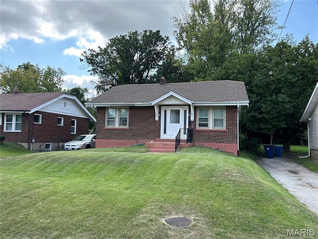 114 Bernhardt Ave, Saint Louis, MO 63121 - bungalow-style home featuring brick siding, a front yard, and roof with shingles