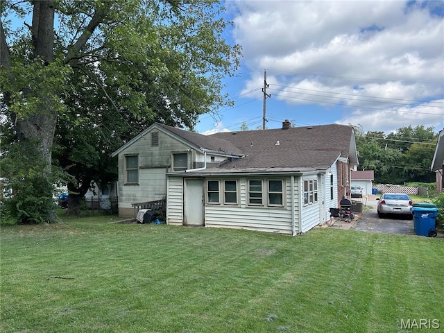 114 Bernhardt Ave, Saint Louis, MO 63121 - rear view of house featuring a yard and roof with shingles
