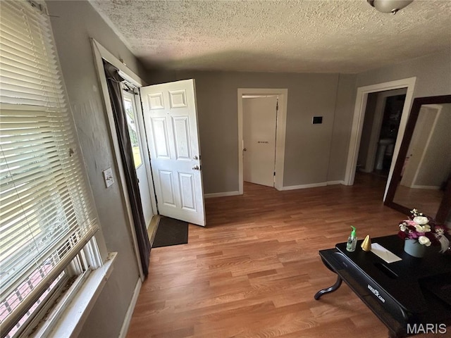 114 Bernhardt Ave, Saint Louis, MO 63121 - hallway with light wood-style flooring and a textured ceiling
