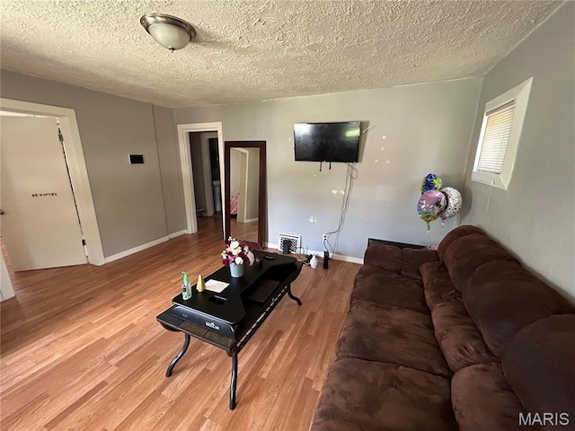 114 Bernhardt Ave, Saint Louis, MO 63121 - living area featuring light wood finished floors and a textured ceiling