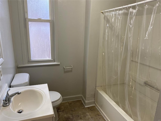 bathroom with toilet, baseboards, shower / bath combo, and vanity