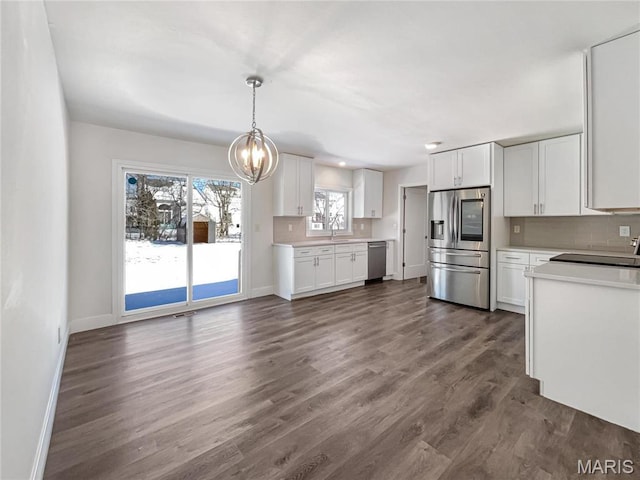 38 N Lang Dr, Ofallon, MO 63366 - kitchen featuring appliances with stainless steel finishes, tasteful backsplash, white cabinetry, and light countertops