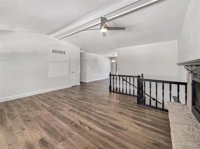 38 N Lang Dr, Ofallon, MO 63366 - empty room with wood finished floors, a ceiling fan, and a fireplace with raised hearth