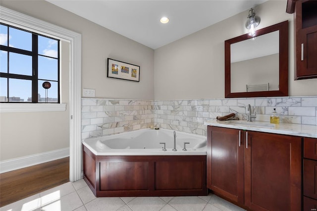 full bathroom with a jetted tub, vanity, tile patterned floors, baseboards, and recessed lighting