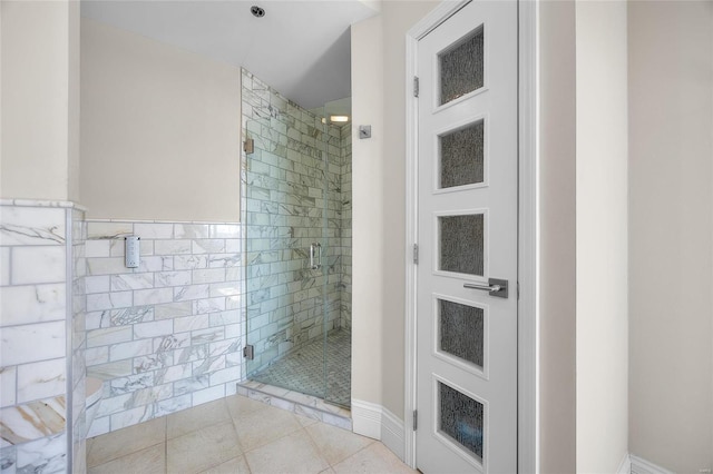 full bathroom featuring a stall shower and tile patterned flooring