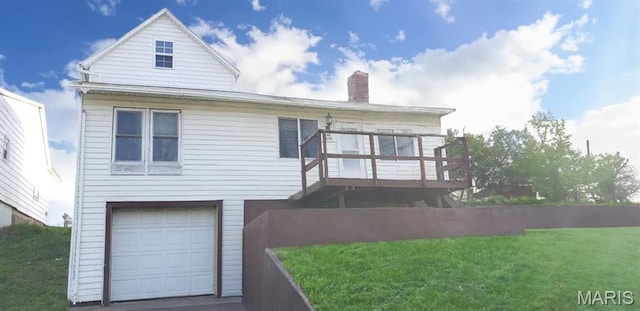 340 Main St, Hamilton, IL 62341 - back of house with a chimney, a wooden deck, a garage, and a yard