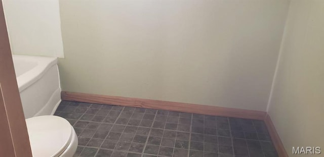 340 Main St, Hamilton, IL 62341 - bathroom featuring toilet, baseboards, and tile patterned floors