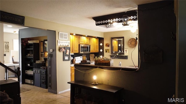 338 Mont Pellier St, Bonne Terre, MO 63628 - interior space with stainless steel microwave, range, and light tile patterned floors