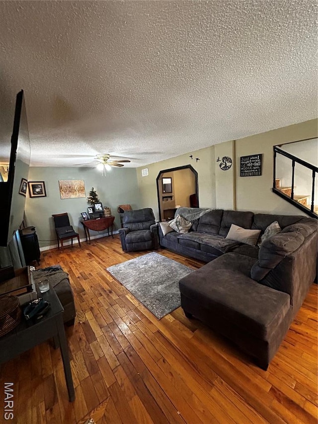 338 Mont Pellier St, Bonne Terre, MO 63628 - living room with a textured ceiling, ceiling fan, hardwood / wood-style floors, and arched walkways