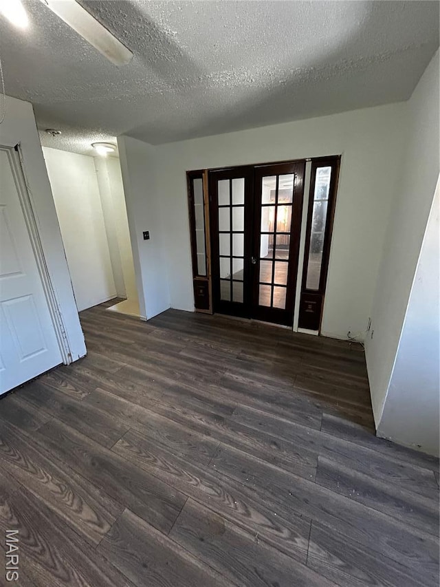 338 Mont Pellier St, Bonne Terre, MO 63628 - empty room featuring dark wood-type flooring, a textured ceiling, and french doors