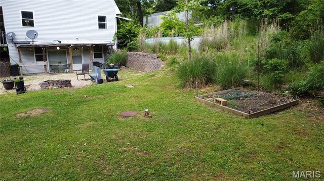 338 Mont Pellier St, Bonne Terre, MO 63628 - view of grassy yard with a vegetable garden