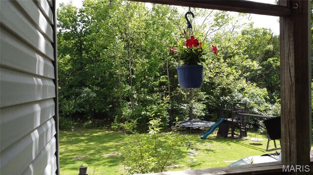 338 Mont Pellier St, Bonne Terre, MO 63628 - view of grassy yard featuring a trampoline and a playground