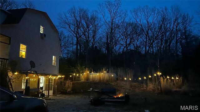 338 Mont Pellier St, Bonne Terre, MO 63628 - yard at twilight with a fire pit
