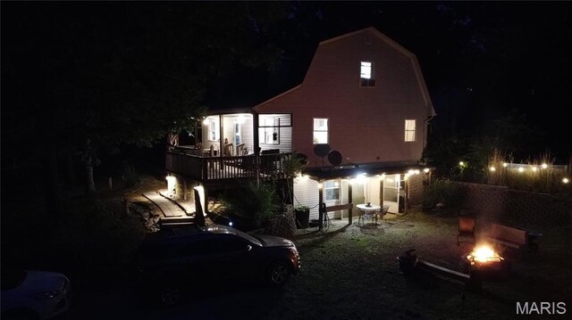 338 Mont Pellier St, Bonne Terre, MO 63628 - back of house at twilight with an outdoor fire pit and a gambrel roof
