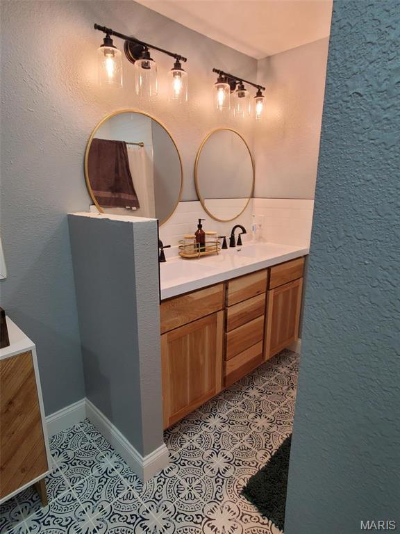1028 County Road 606, Cape Girardeau, MO 63701 - bathroom featuring double vanity and tile patterned flooring