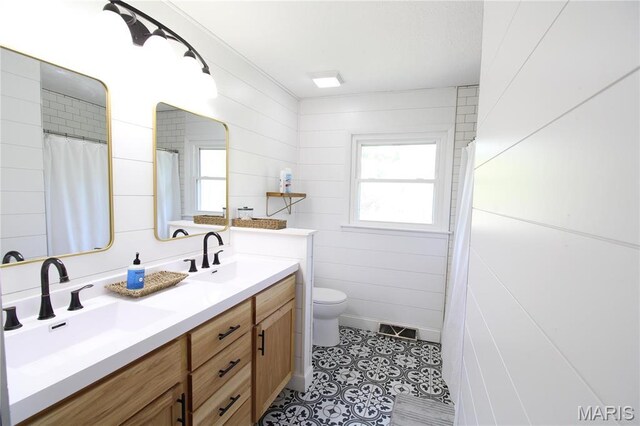 1028 County Road 606, Cape Girardeau, MO 63701 - bathroom featuring double vanity, toilet, and tile patterned flooring