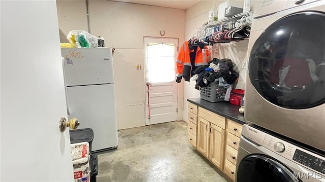 1028 County Road 606, Cape Girardeau, MO 63701 - laundry room featuring stacked washer / dryer and cabinet space