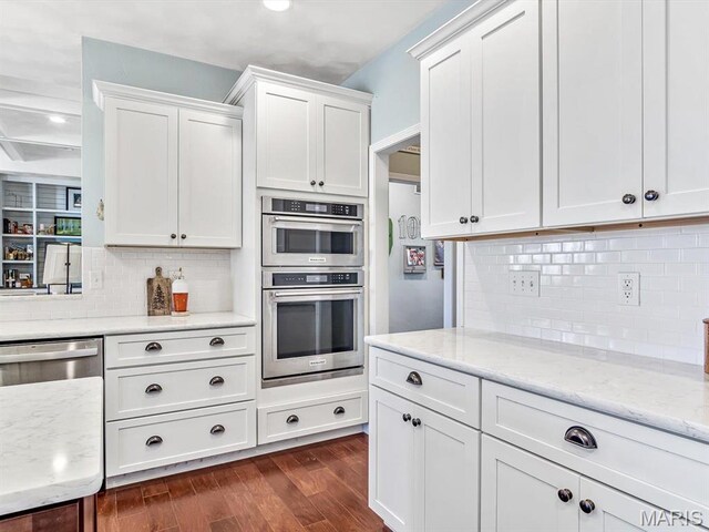 103 Evergreen Ct, Waterloo, IL 62298 - kitchen featuring stainless steel appliances, white cabinetry, dark wood-type flooring, decorative backsplash, and light stone counters
