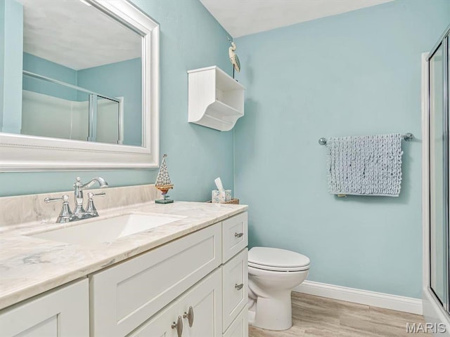 103 Evergreen Ct, Waterloo, IL 62298 - bathroom featuring wood finished floors, a shower stall, vanity, and baseboards