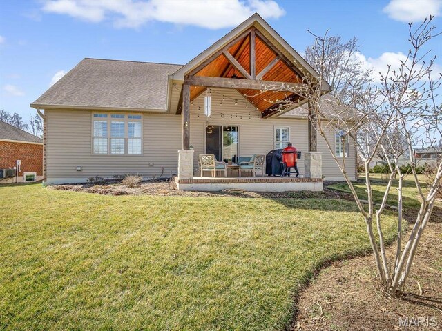 103 Evergreen Ct, Waterloo, IL 62298 - rear view of house featuring a lawn, roof with shingles, and a patio area