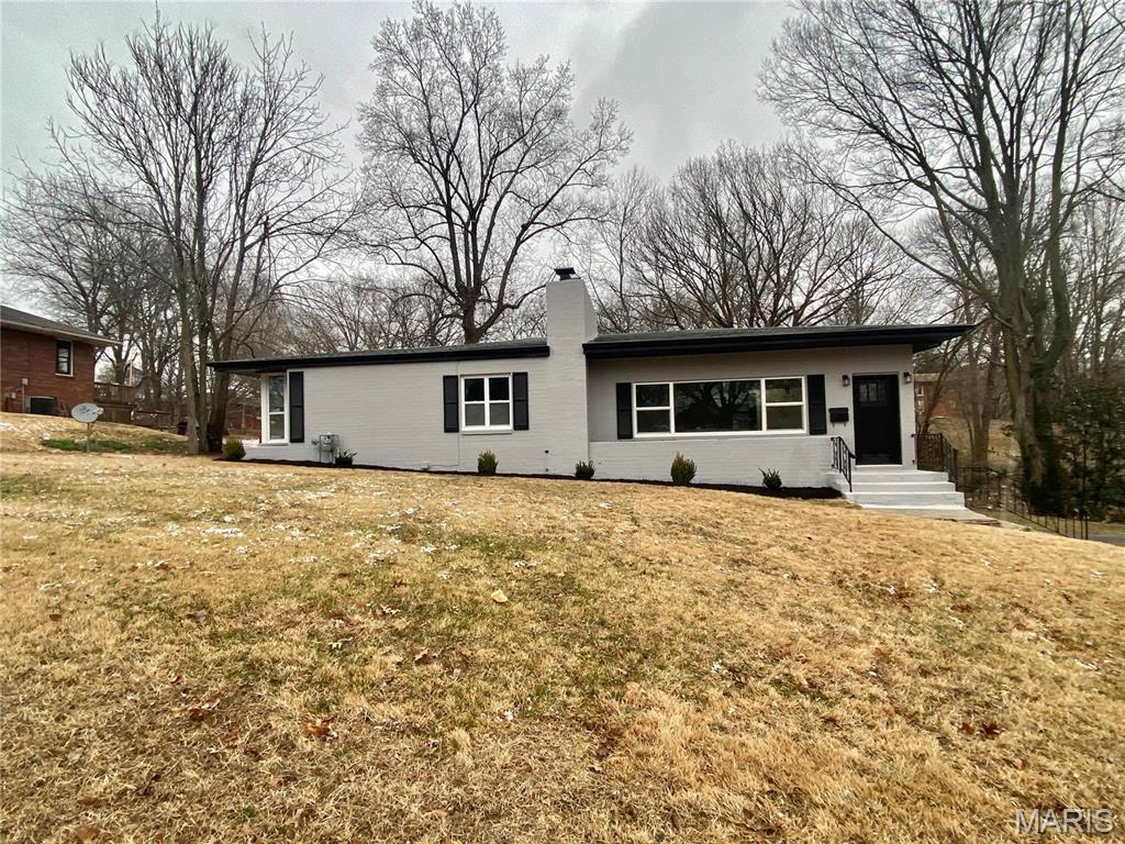 820 Valley Dr, East Alton, IL 62024 - back of house with a chimney and a lawn