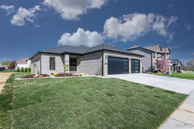 1519 Oglesby Dr, Edwardsville, IL 62025 - view of front of house with a garage, a front lawn, concrete driveway, and brick siding