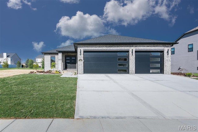 1519 Oglesby Dr, Edwardsville, IL 62025 - view of front of house featuring a garage, concrete driveway, brick siding, and a front lawn