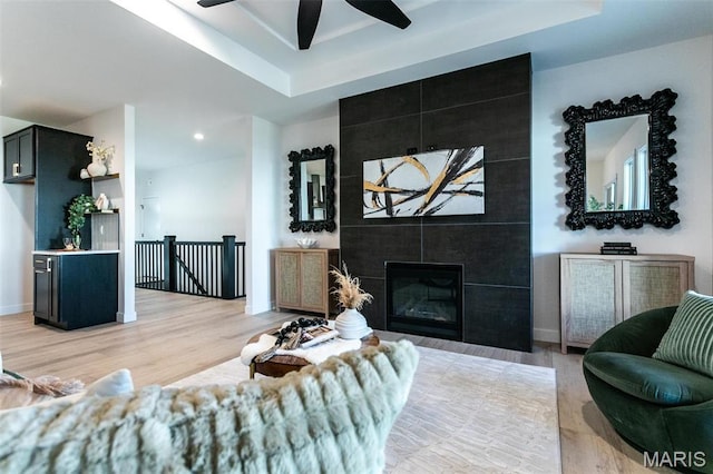 1519 Oglesby Dr, Edwardsville, IL 62025 - living area featuring a tray ceiling, ceiling fan, light wood finished floors, a tile fireplace, and recessed lighting