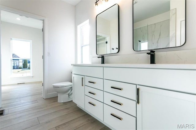 1519 Oglesby Dr, Edwardsville, IL 62025 - full bathroom with double vanity, wood finished floors, and a marble finish shower