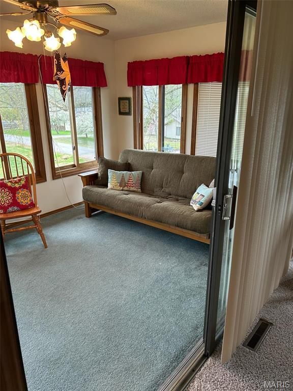 266 Hunt Club Cir, Galena, MO 65656 - carpeted living area with a ceiling fan and baseboards