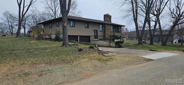 266 Hunt Club Cir, Galena, MO 65656 - view of front of home featuring a chimney, asphalt driveway, a garage, and a front yard