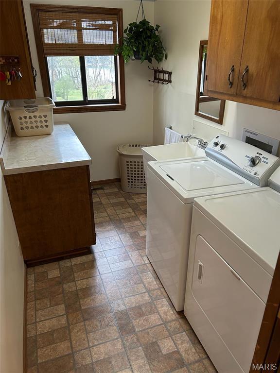 266 Hunt Club Cir, Galena, MO 65656 - laundry room featuring cabinet space, washer and clothes dryer, brick patterned floors, and baseboards
