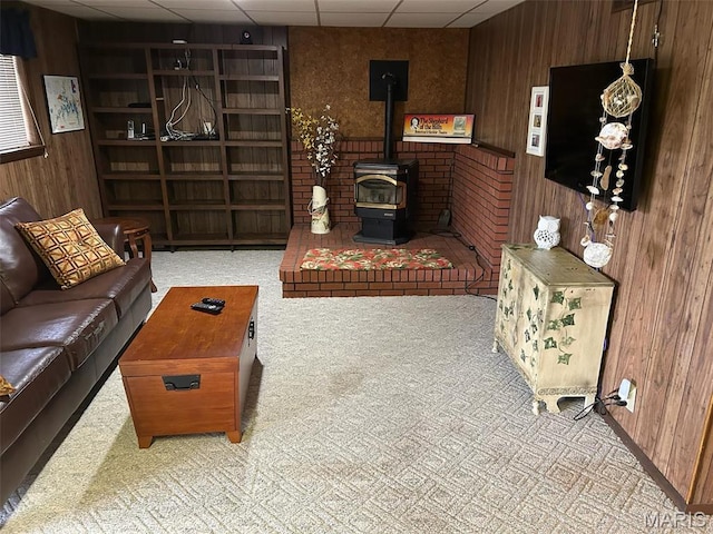 266 Hunt Club Cir, Galena, MO 65656 - living area with wooden walls, carpet, a drop ceiling, and a wood stove