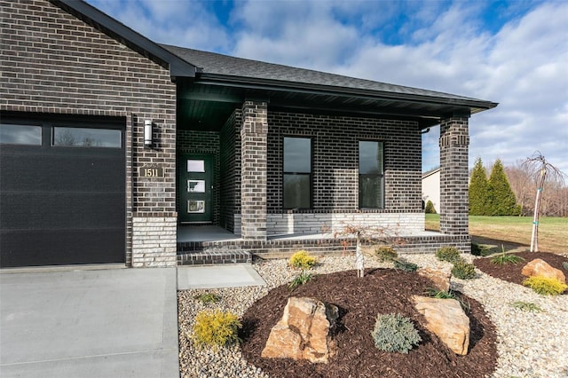 1511 Oglesby Dr, Edwardsville, IL 62025 - view of exterior entry featuring brick siding and an attached garage