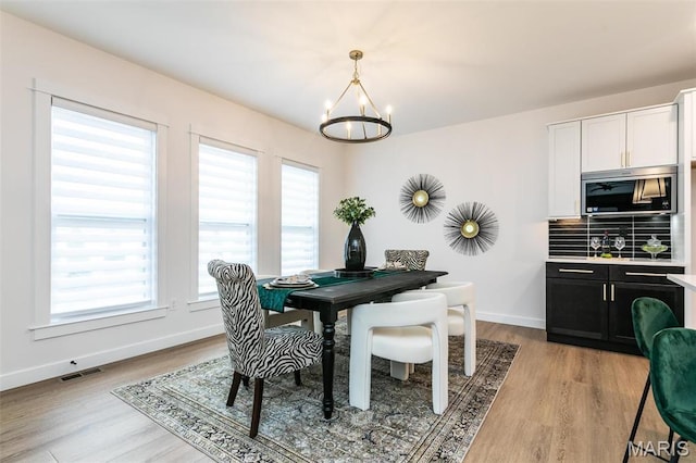 1511 Oglesby Dr, Edwardsville, IL 62025 - dining room featuring a chandelier, healthy amount of natural light, and light wood-style flooring
