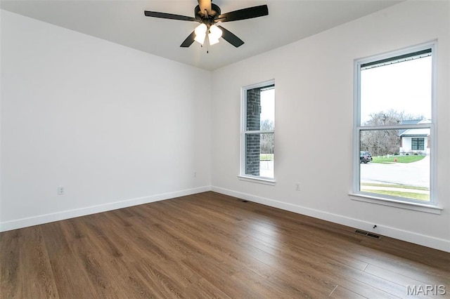 1511 Oglesby Dr, Edwardsville, IL 62025 - unfurnished room with healthy amount of natural light, dark wood finished floors, and a ceiling fan