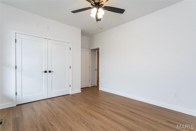 1511 Oglesby Dr, Edwardsville, IL 62025 - unfurnished bedroom with wood finished floors, ceiling fan, and a closet