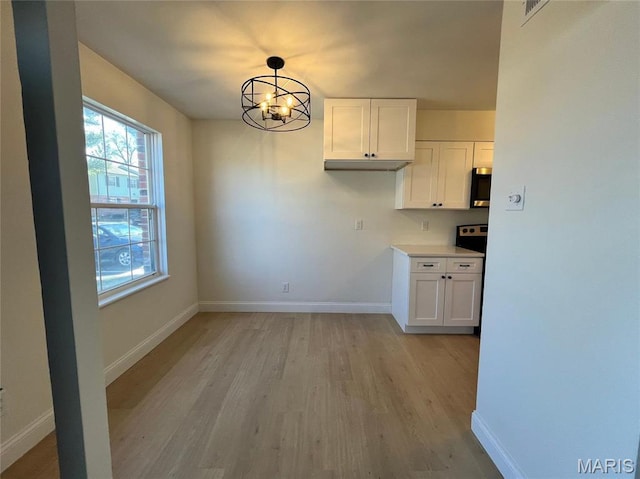 1407 Vadera Ct, Fenton, MO 63026 - unfurnished dining area featuring light wood finished floors, baseboards, and a chandelier