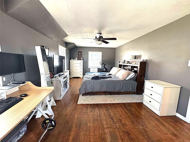 bedroom featuring dark wood-type flooring, an office area, ceiling fan, a textured ceiling, and baseboards