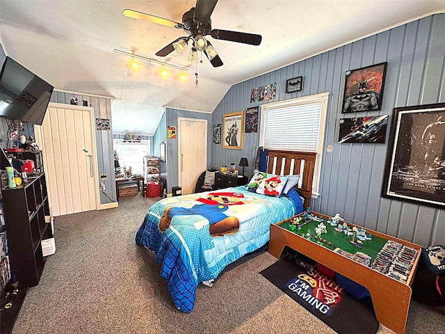 carpeted bedroom with a ceiling fan and lofted ceiling