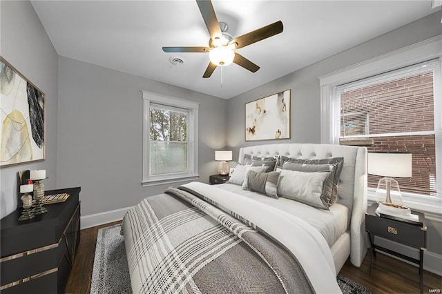 bedroom with wood finished floors, baseboards, and a ceiling fan