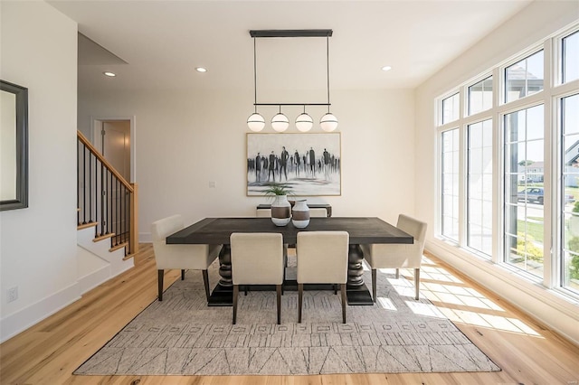 dining space with wood finished floors, stairs, recessed lighting, and baseboards