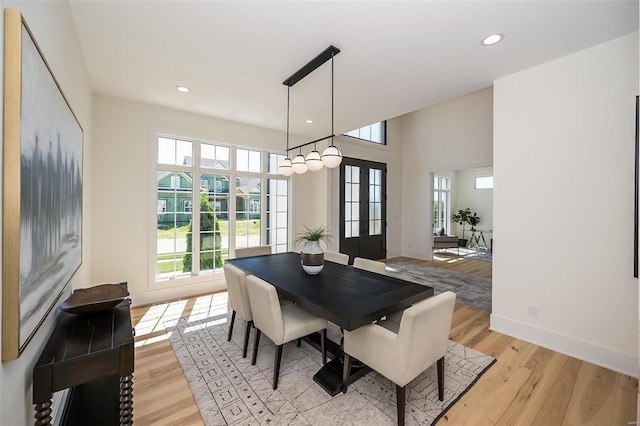 dining room featuring light wood-type flooring, recessed lighting, baseboards, and french doors