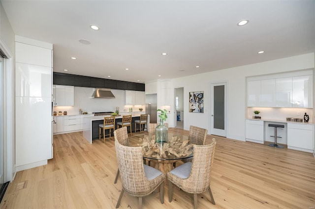 dining room featuring light wood-type flooring and recessed lighting